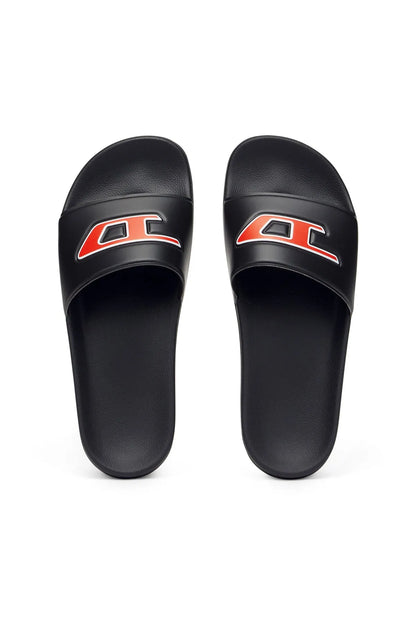 Black slide sandals with red-orange logo patch on front strap, pair view