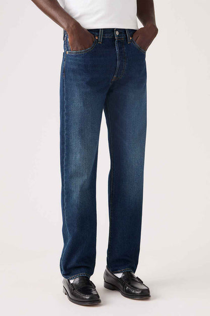 Dark wash denim jeans close-up of straight legs, stitched pockets, and belt loops