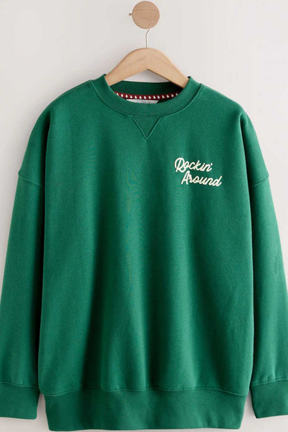 Forest green sweatshirt on hanger with 'Rockin' Around' chest print