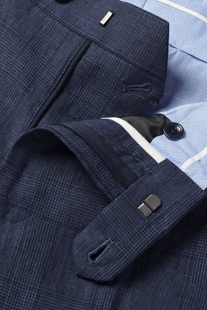 Checked dress trousers close-up with welt pockets, belt loops, and button tab