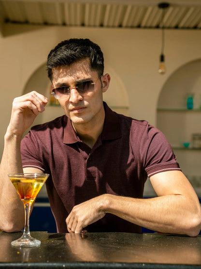 Maroon polo shirt with short sleeves and collar detail, model in sunglasses