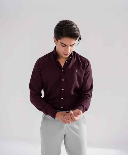 Fitted maroon button-up shirt with long sleeves and button front