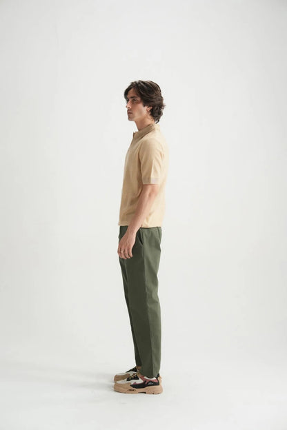 Beige polo shirt side profile with short sleeves and open collar.