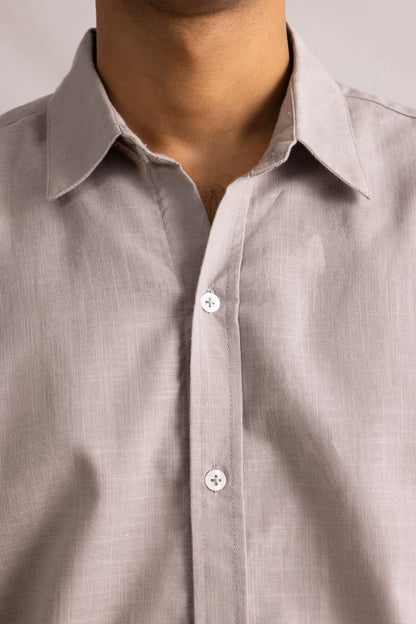Close-up of grey button-up shirt neckline and button placket