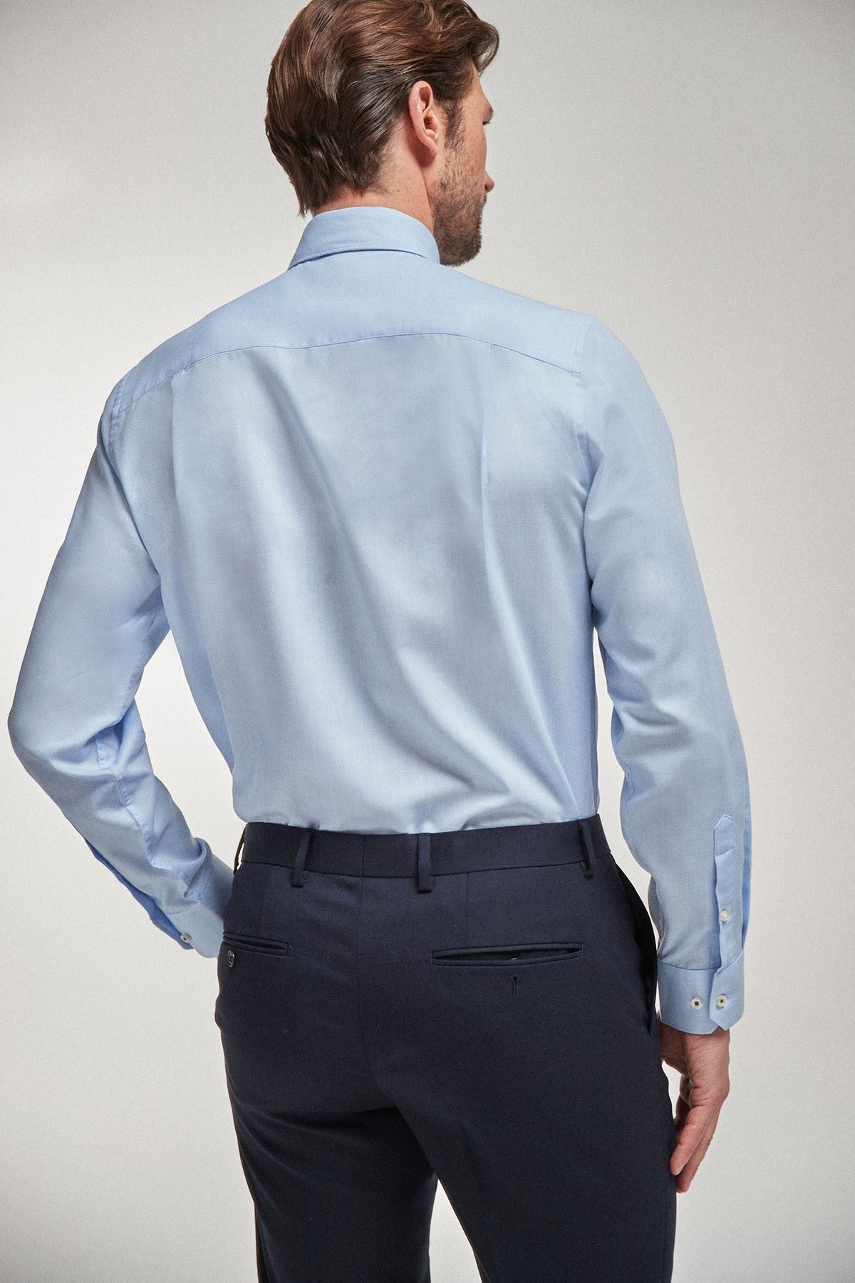 Light blue dress shirt back view with button cuffs