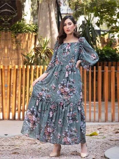 Floral midi dress with dusty teal base, pink floral print, round neckline, tiered ruffles