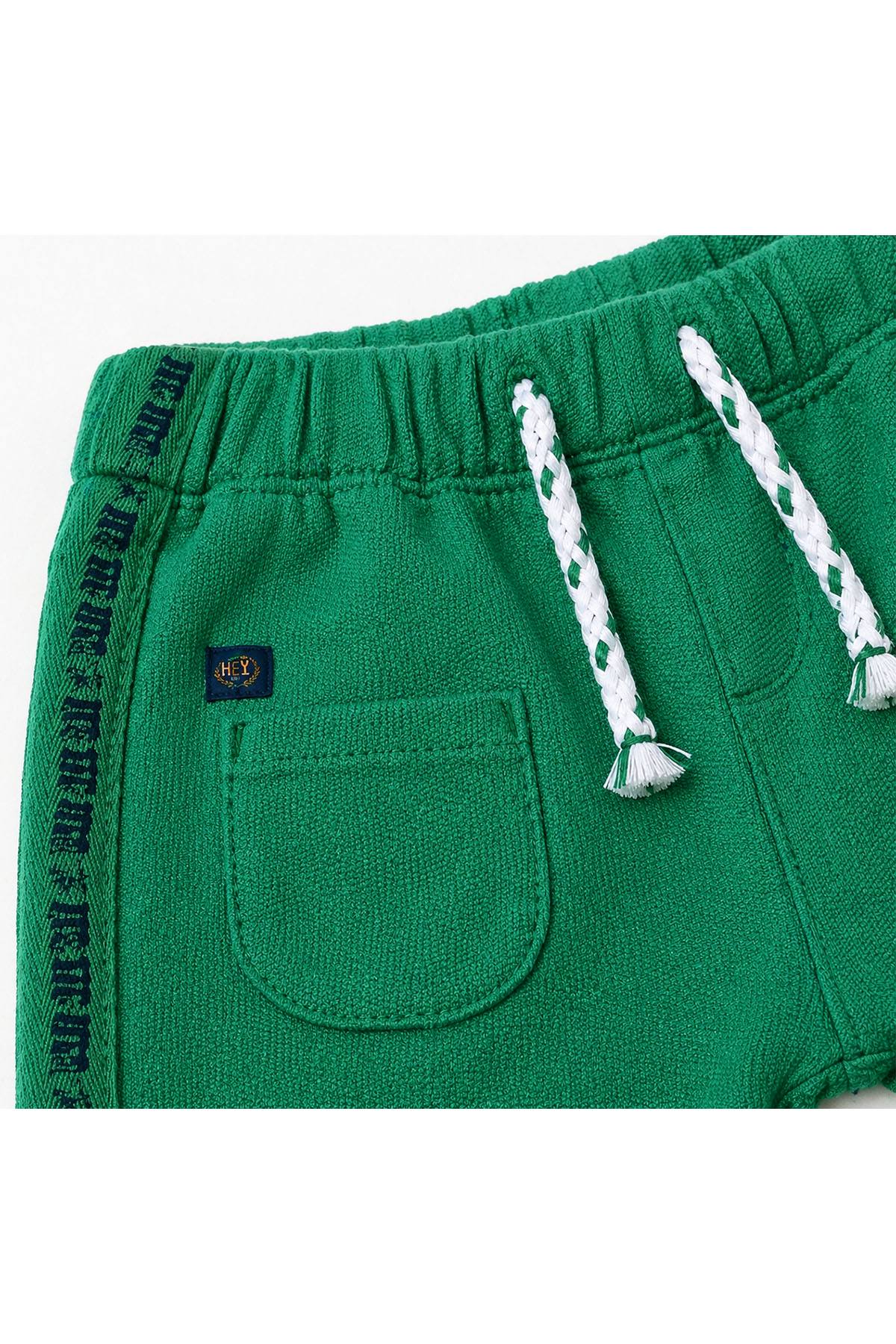 Green baby pants close-up of elastic waistband and drawstring