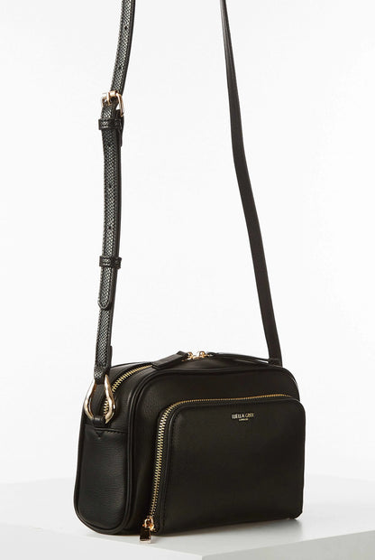 Black mini crossbody bag with long strap and gold zipper hardware