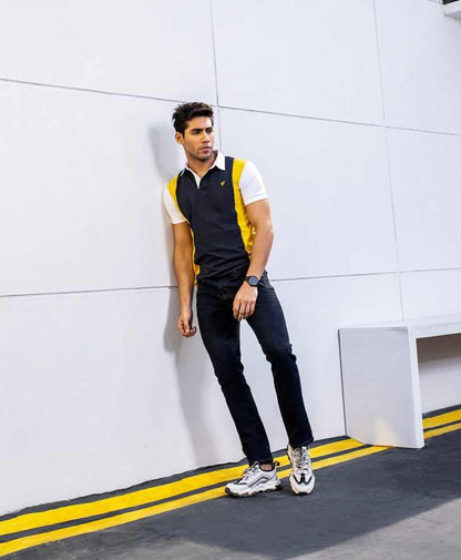 Men's navy and yellow colorblock polo sweater vest with white sleeves and jeans