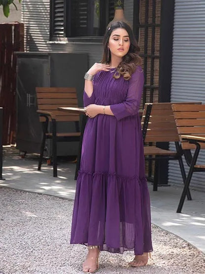 Purple tiered maxi dress with pleated tiers, round neckline, and 3/4 sleeves