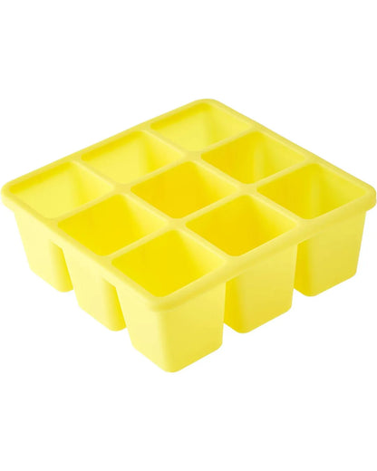 Yellow ice cube tray with 12 square compartments