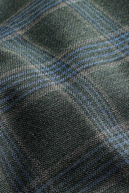 Green and blue plaid suiting fabric texture close-up
