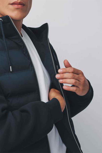 Navy puffer jacket detail with zip front and partial white inner layer