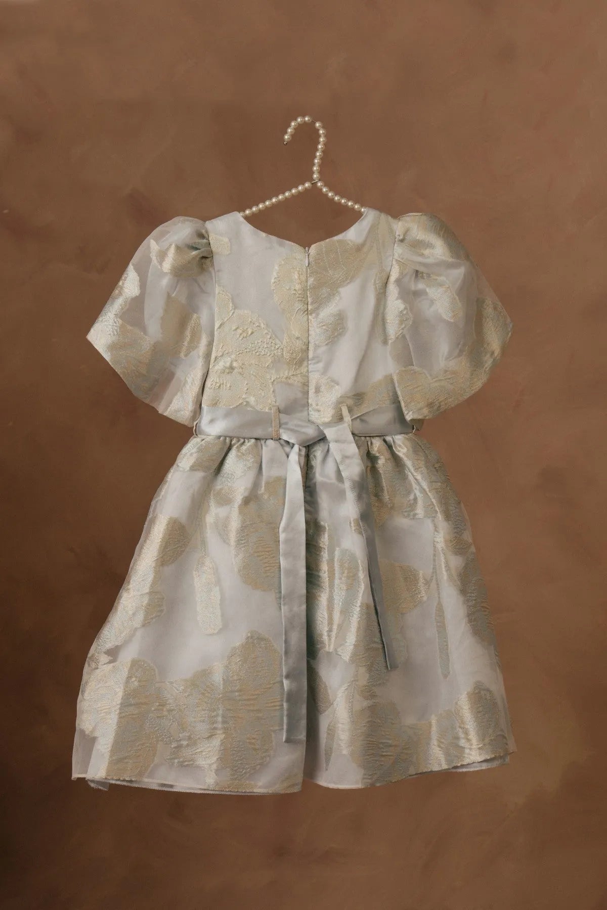 Licci girls cream dress with gold animal print, gathered skirt and front button closure