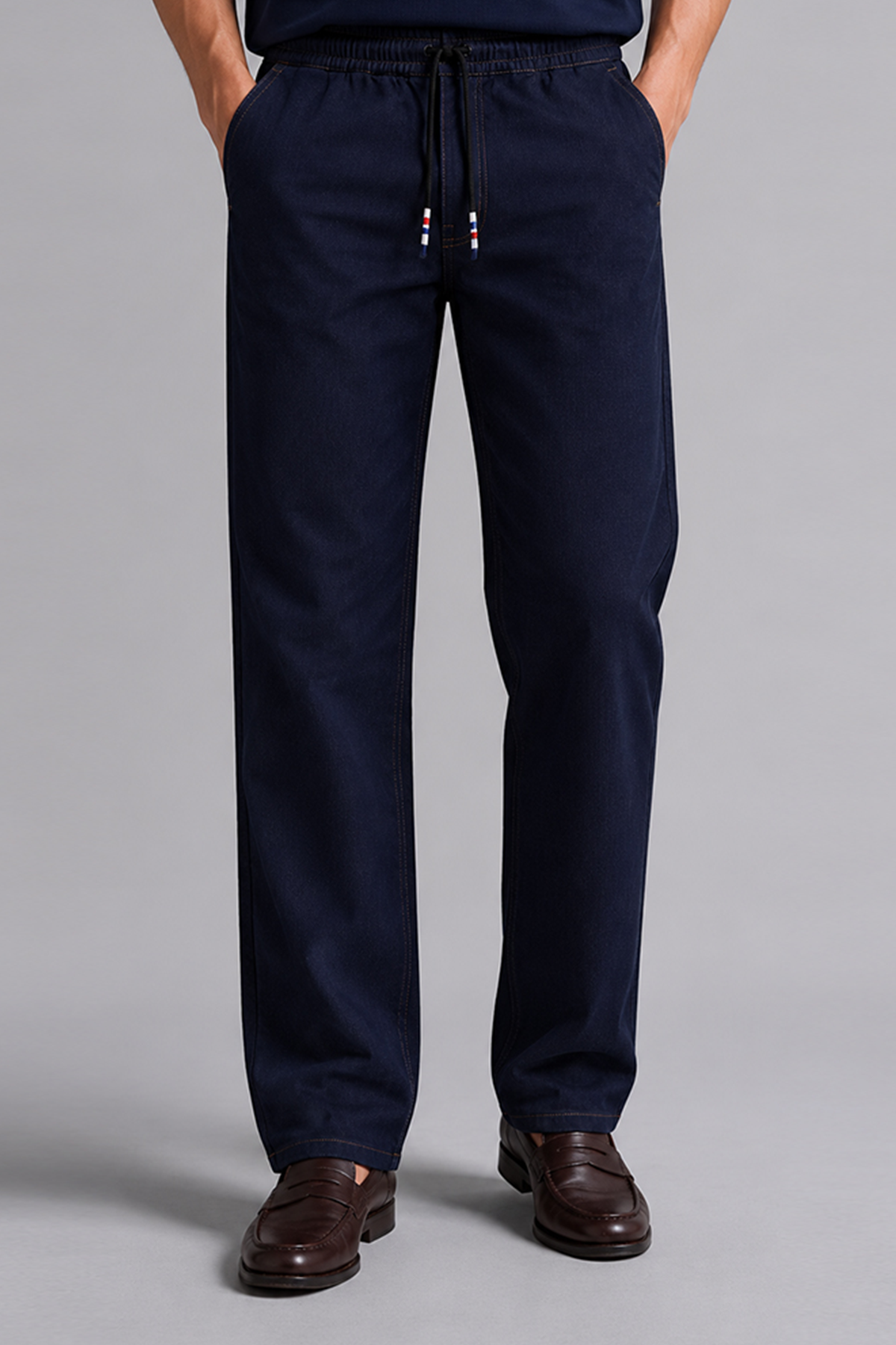 Navy blue drawstring trousers with tapered legs and ankle cuffs