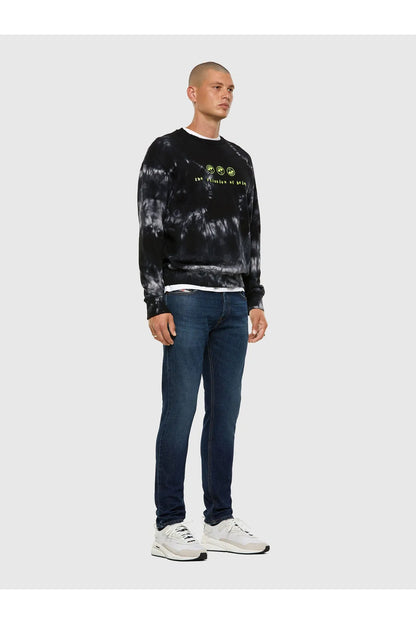 Blue denim jeans worn with white sneakers; slim straight leg