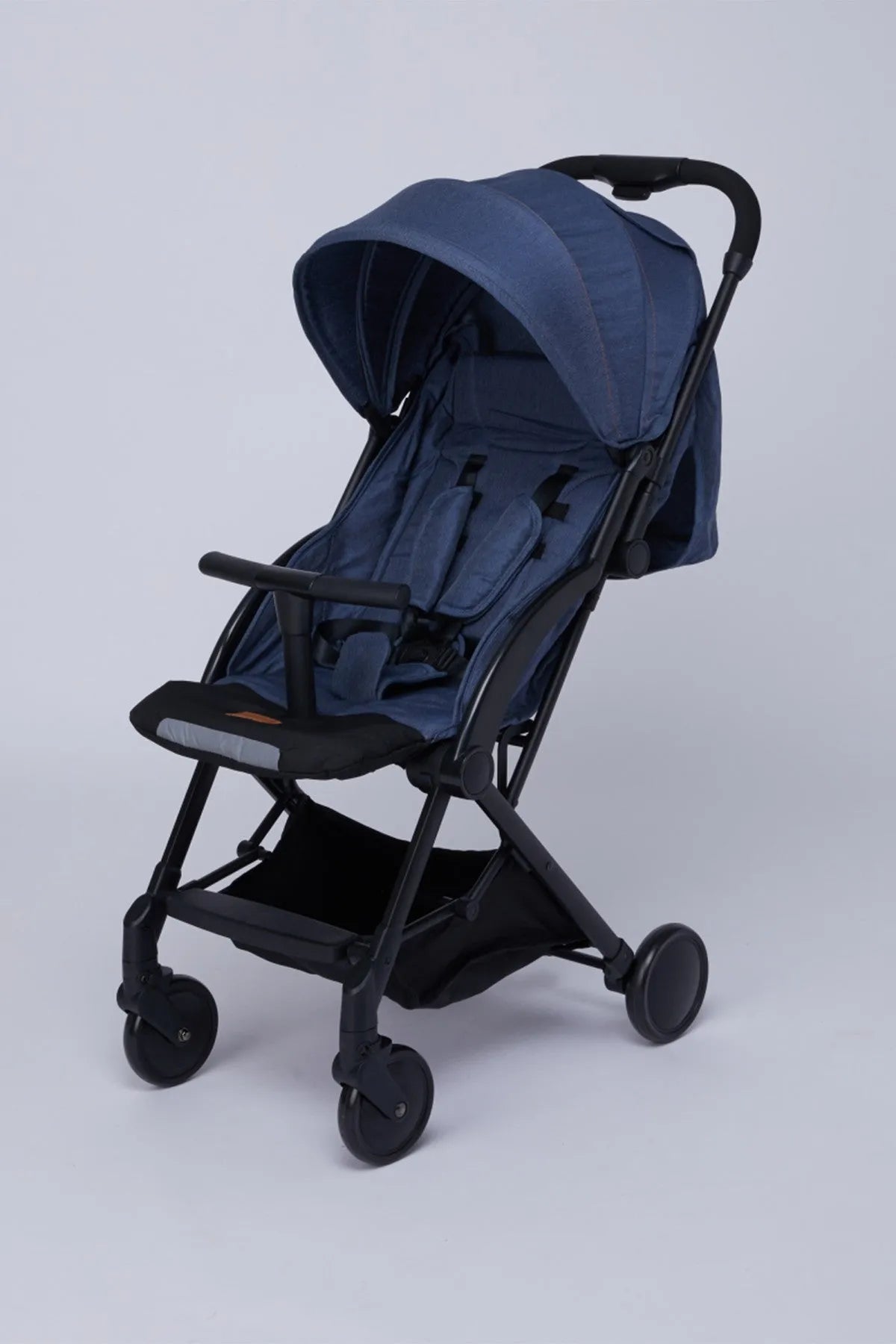 Blue stroller with canopy, padded seat, and safety harness, four-wheel design.