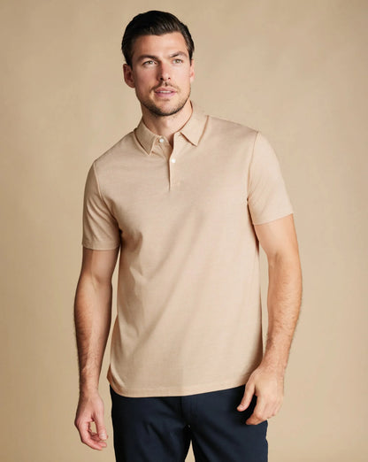 Charles Tyrwhitt polo shirt on model, light tan short-sleeve knit