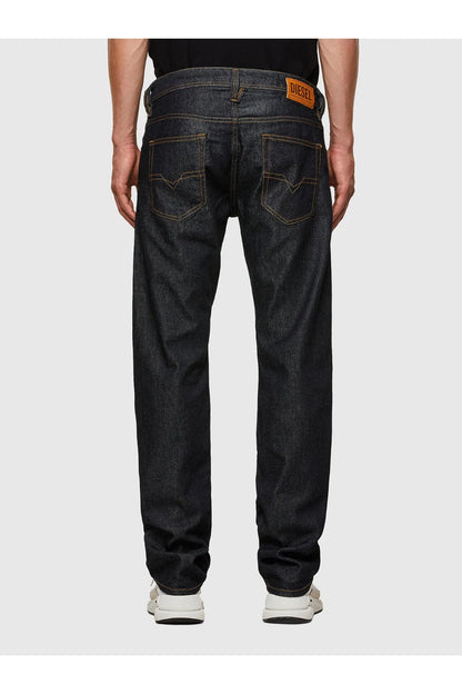 Dark indigo denim jeans, five-pocket style with orange stitching and DIESEL patch label