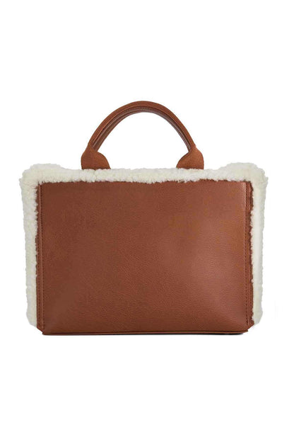 Brown rectangular handbag with white shearling trim and short top handles
