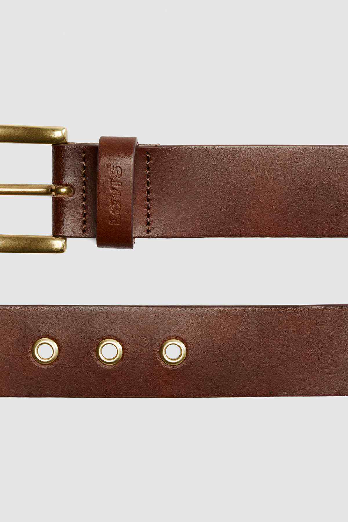 Brown leather belt with brass buckle and eyelet hardware on strap