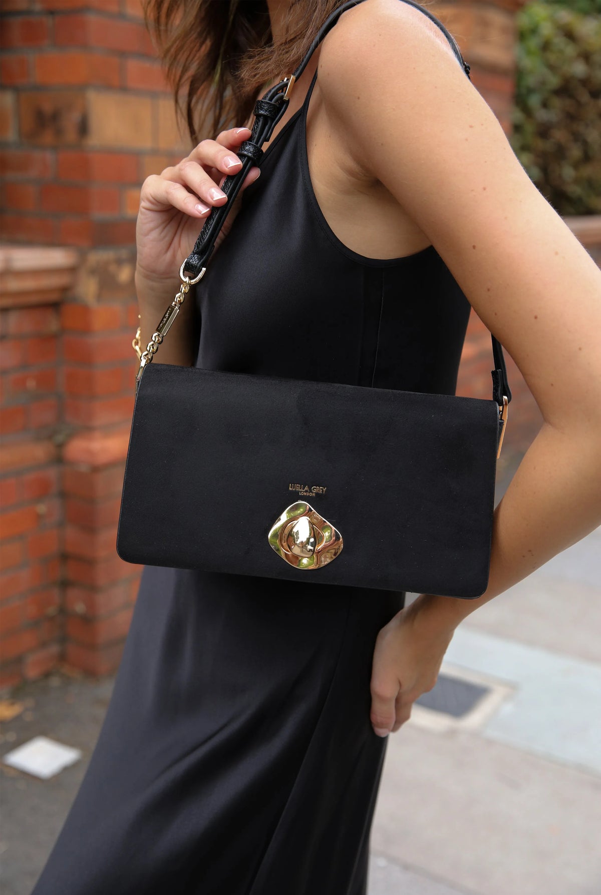 Black shoulder bag crossbody with gold emblem front and chain strap