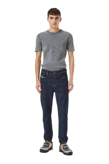 Dark blue denim jeans front view with 5 pockets and belt loops on model.