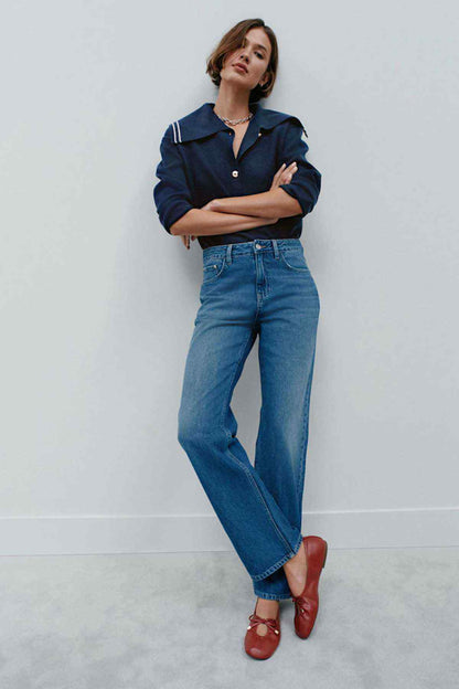 Mid-blue denim jeans with straight-to-wide leg and front pockets
