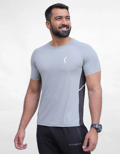 Men's athletic t-shirt in light gray with black side panels and curved chest emblem