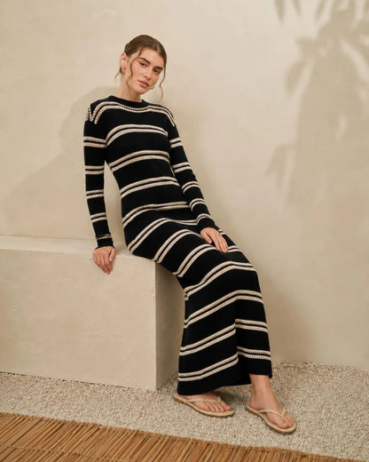 Black and cream striped knit maxi dress, fitted long sleeves, side view
