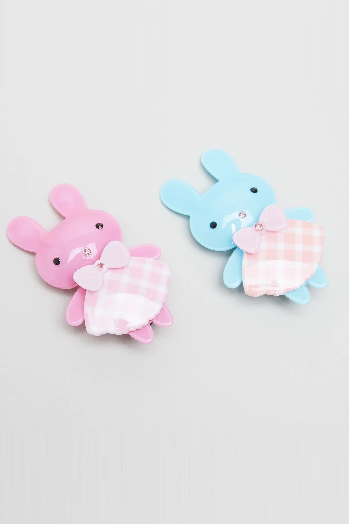 Pair of bunny plush hair clips with plaid bellies, pink bows, and button eyes
