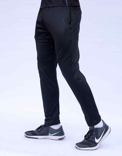 Black jogger pants, side profile with curved seam detailing