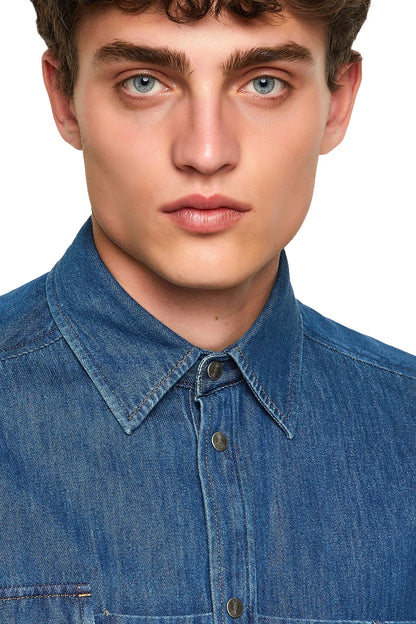 Blue denim button-up shirt close-up: pointed collar and button placket