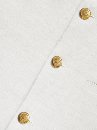 Linen-viscose vest close-up showing gold buttons and stitched front placket