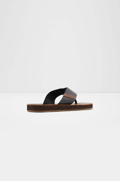 ALDO black thong slide sandals with brown flat sole, side view