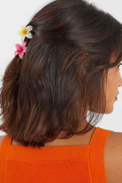 Fuchsia and white flower hair clips, worn in brown hair side view