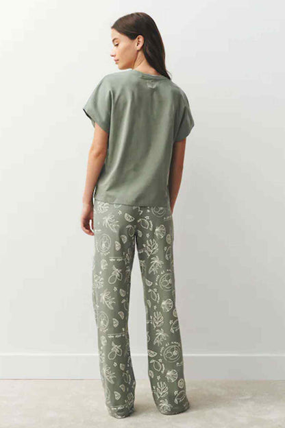 Sage green T-shirt and patterned pajama trousers set, back view