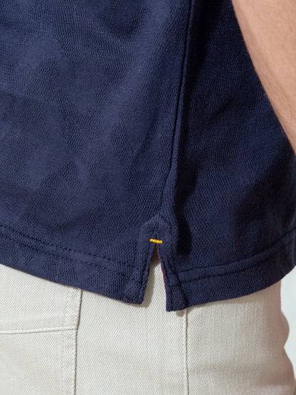 Navy polo shirt hem with side slit and button placket detail