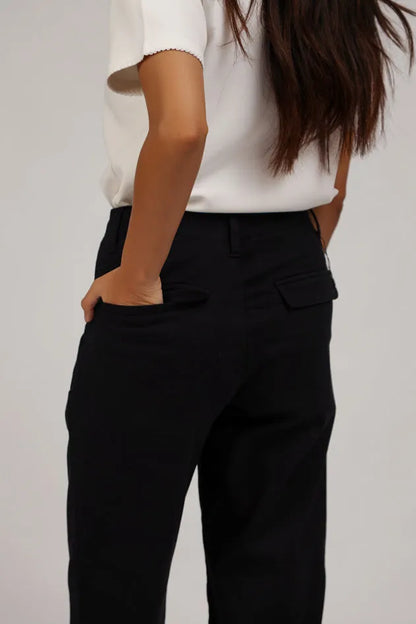 Black cropped trousers close-up with side pocket and belt loops