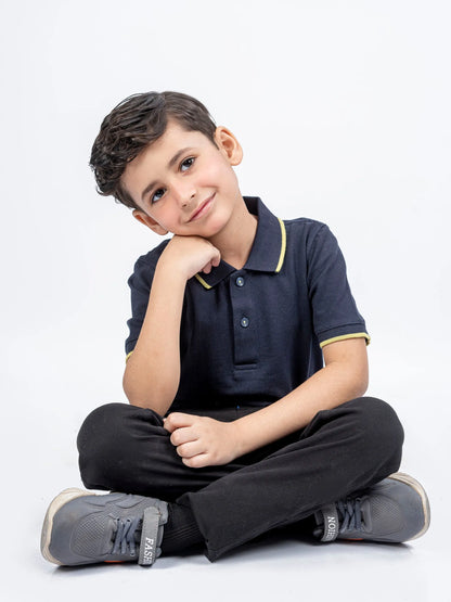 Kids navy polo shirt with yellow-trim collar, short sleeves, and front buttons