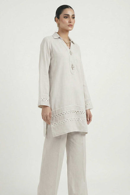 Light grey tunic with scalloped lace hem and embroidered band, paired trousers.