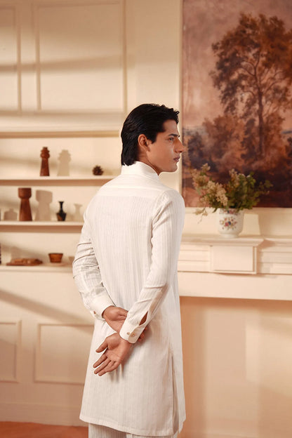 Men's white kurta back view with hands near waist and buttoned neckline