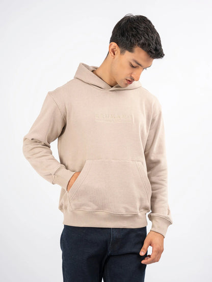 Beige pullover hoodie with hooded neckline and kangaroo pocket; side view