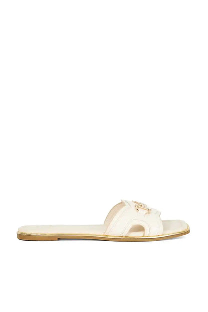 Ecru slip-on mule sandal with gold-edged sole and cutout upper