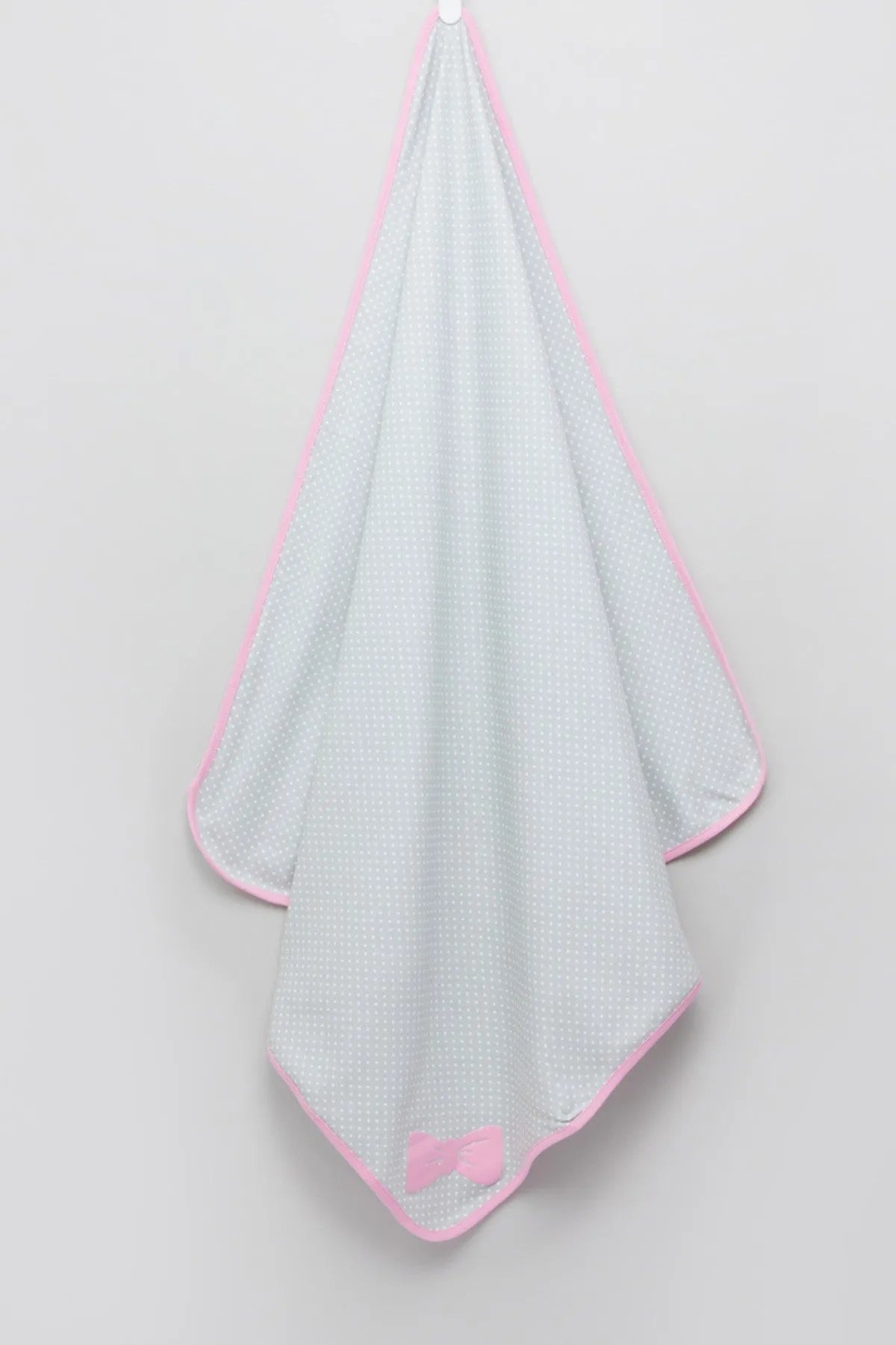 Baby blanket, white dotted with pink edging and bow at bottom