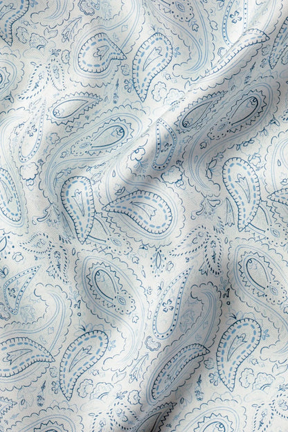 Light blue paisley pocket square fabric close-up with paisley motifs