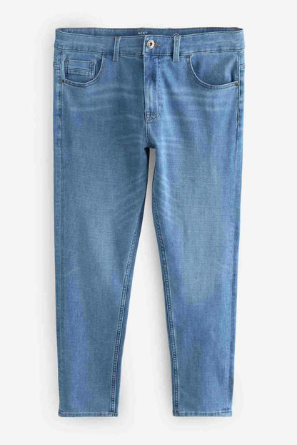 Light blue denim jeans laid flat, button closure, belt loops, and front patch pockets