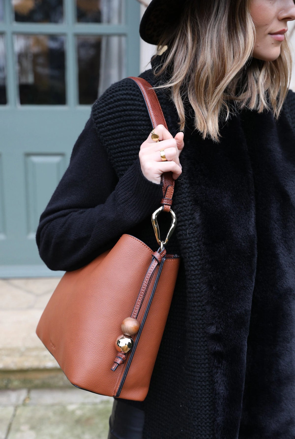 Brown leather hobo bag with gold hardware, top handle and crossbody strap