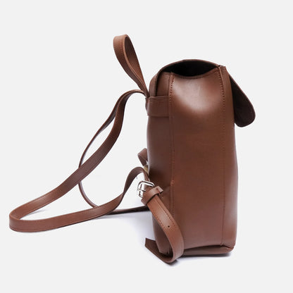 Brown leather mini backpack with top handle strap and side buckle detail; open top.