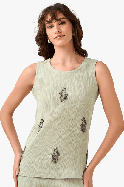 Sleeveless light green top with crew neck and bead floral embroidery